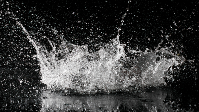 Water exploding on black background