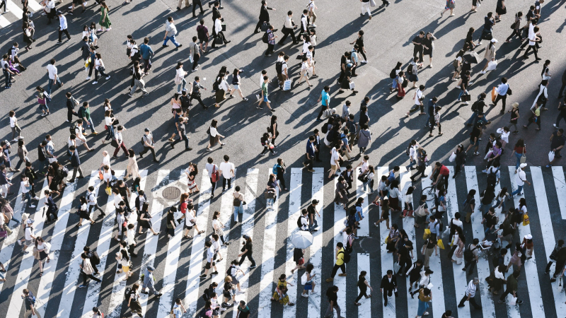 Aerial view of crowd of people walking on crosswalk 