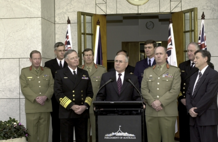 John Howard stands behind podium