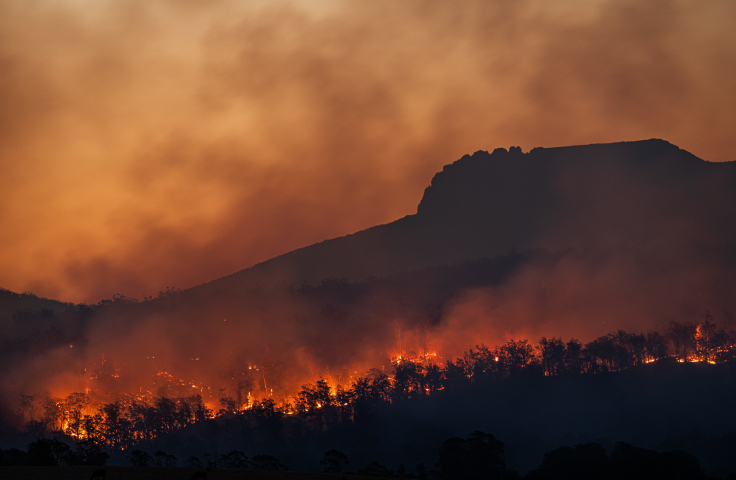 A bushfire burns on a hilly Australian landscape